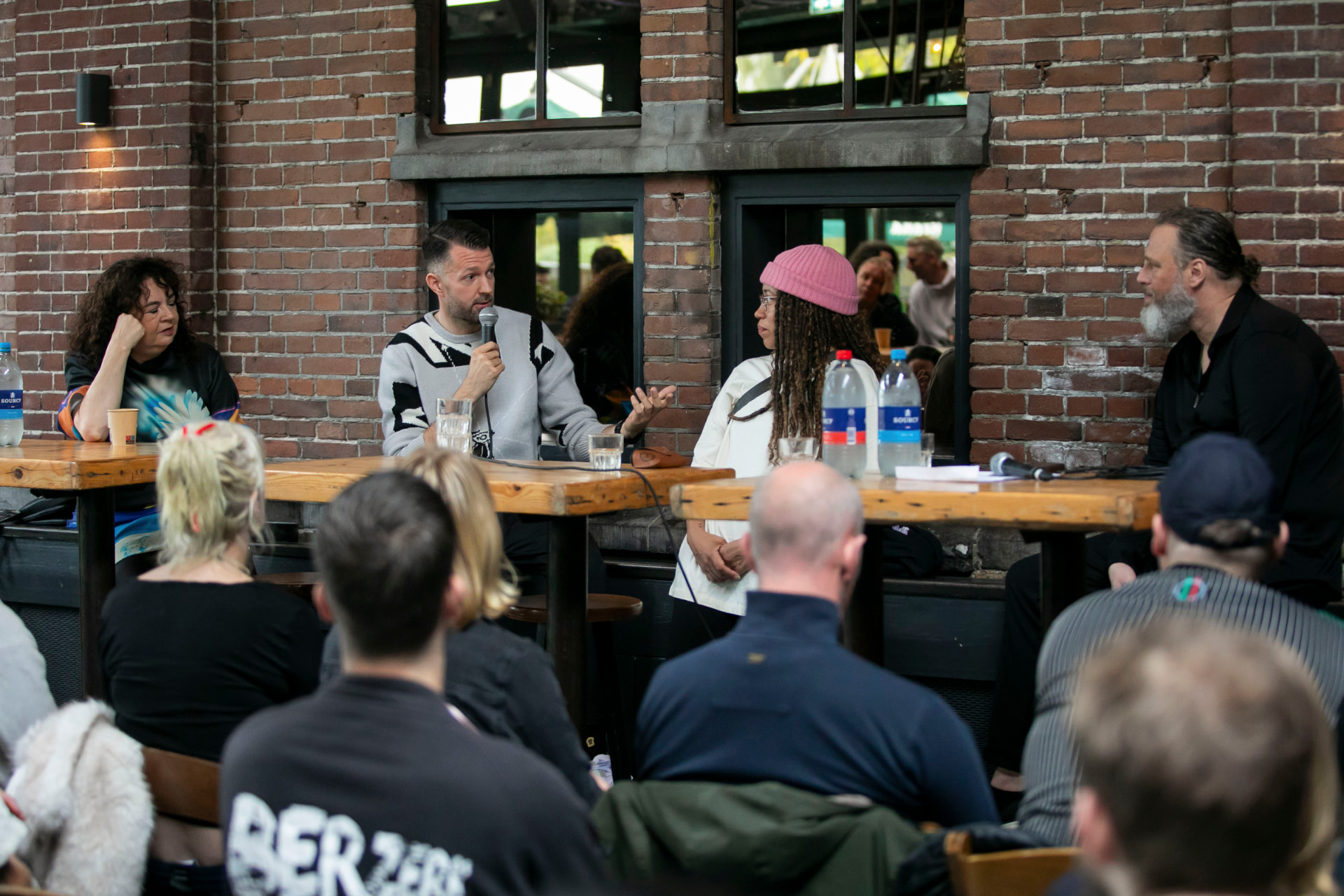 Panelists in conversation in front of a seated audience at WesterUnie