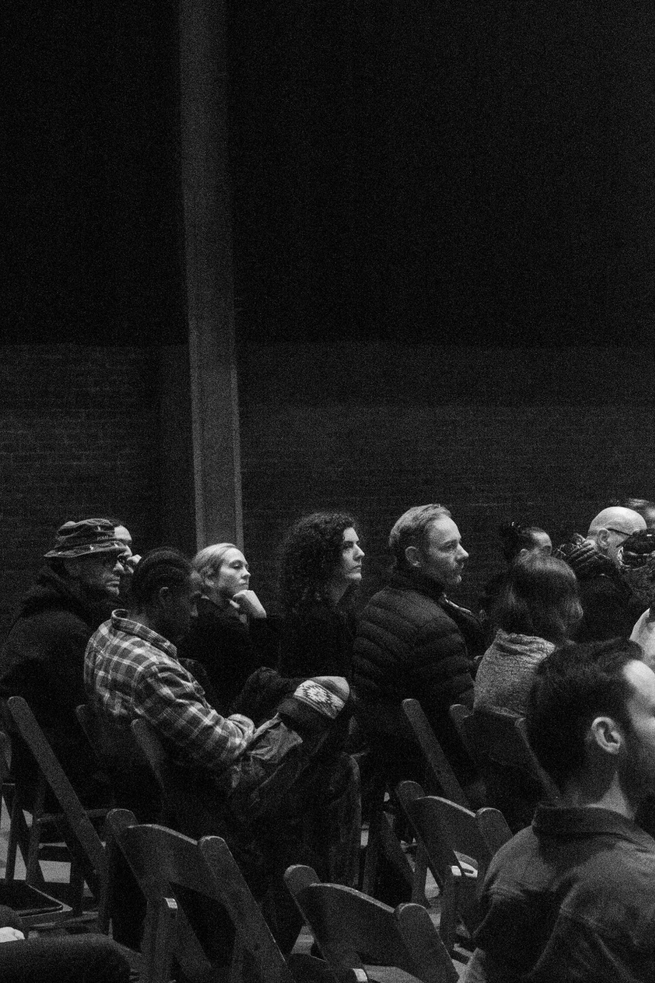 Black and white photo of the seated audience listening attentively