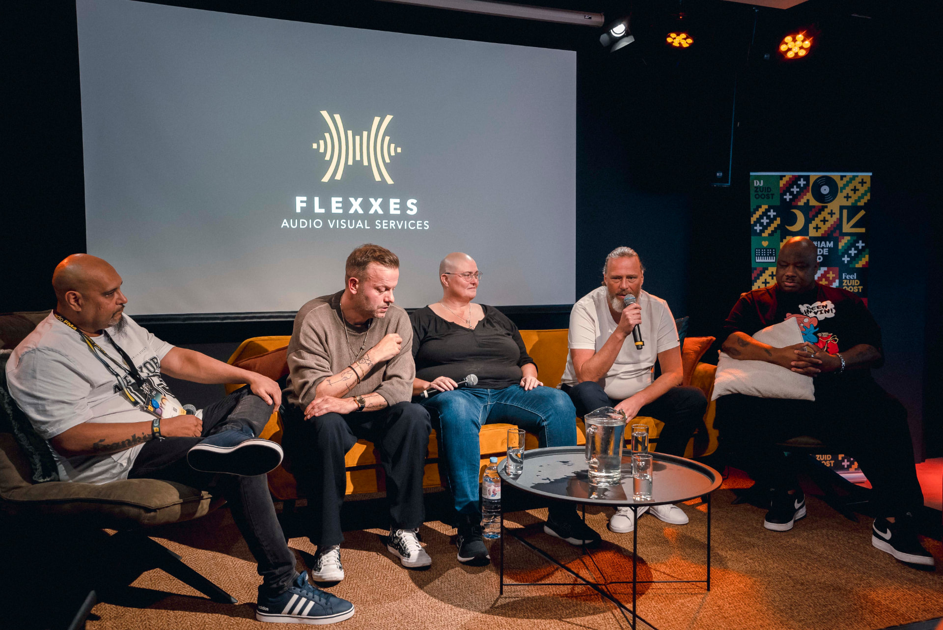 Five panelists seated on stage during the 2023 panel discussion