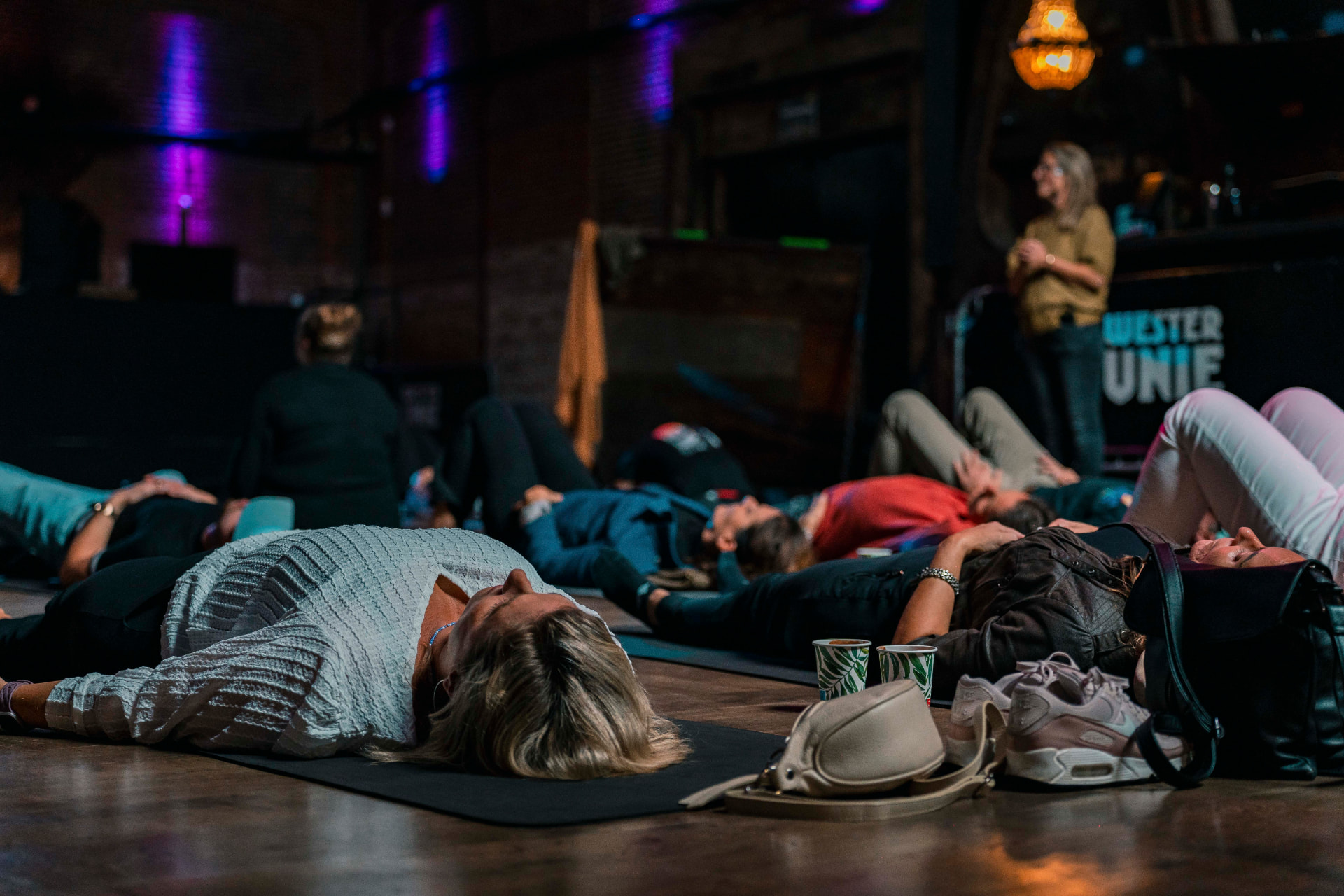 Participants lying on mats during a guided rest moment at WesterUnie