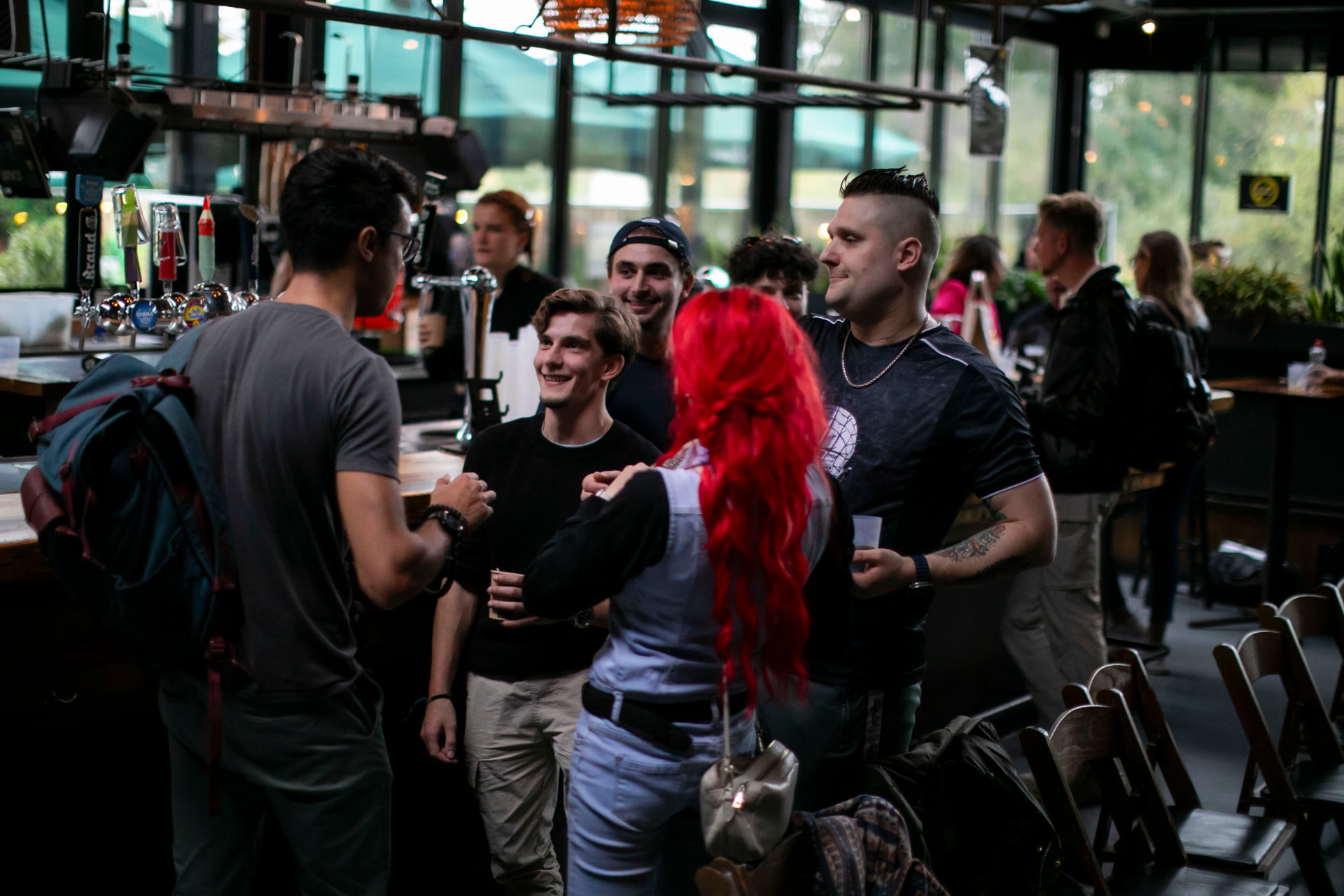 Attendees talking together at the bar between sessions