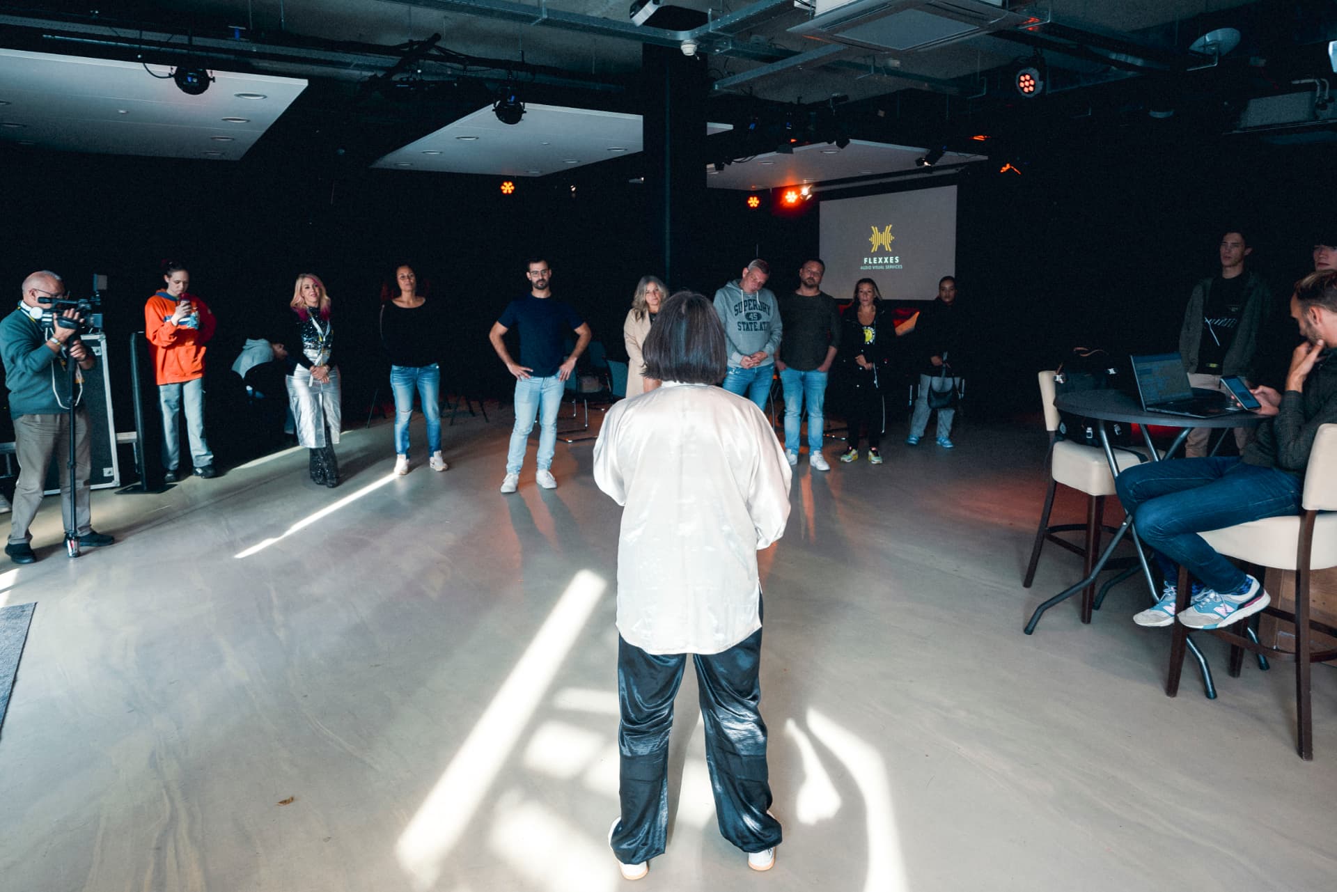 Participants standing in a circle during an experiential wellness session at The Extra Mile