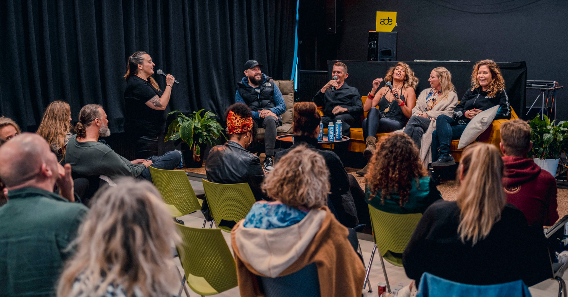 Audience facing the seated panel during the 2023 edition at The Extra Mile