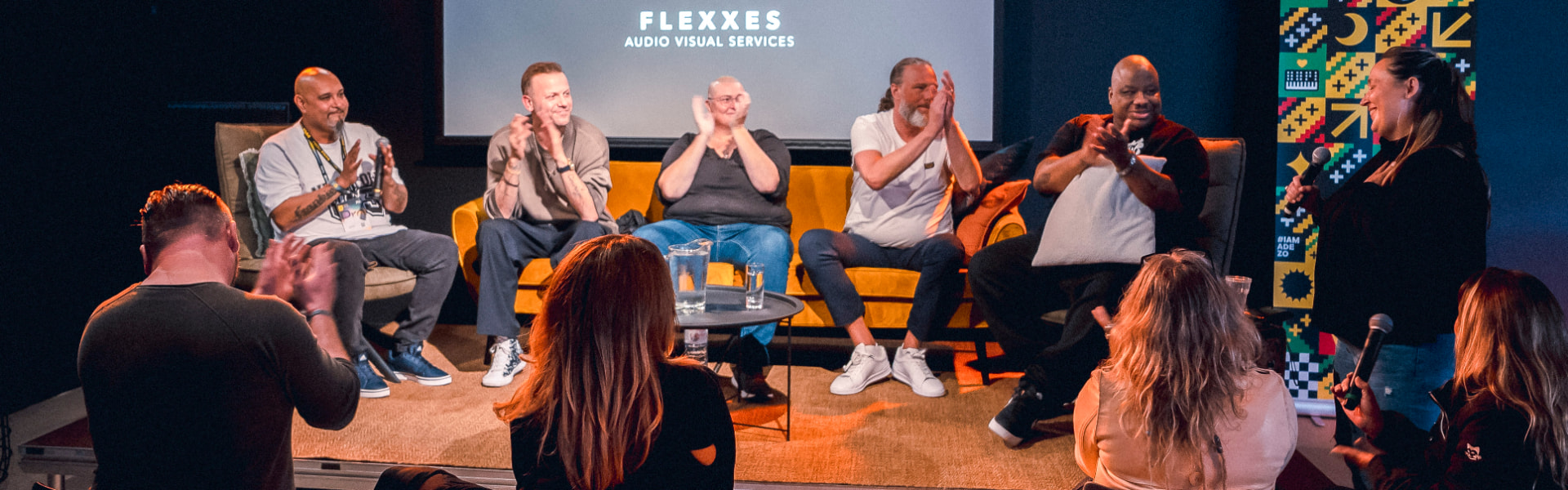 Panelists clapping during the 2023 round table conversation