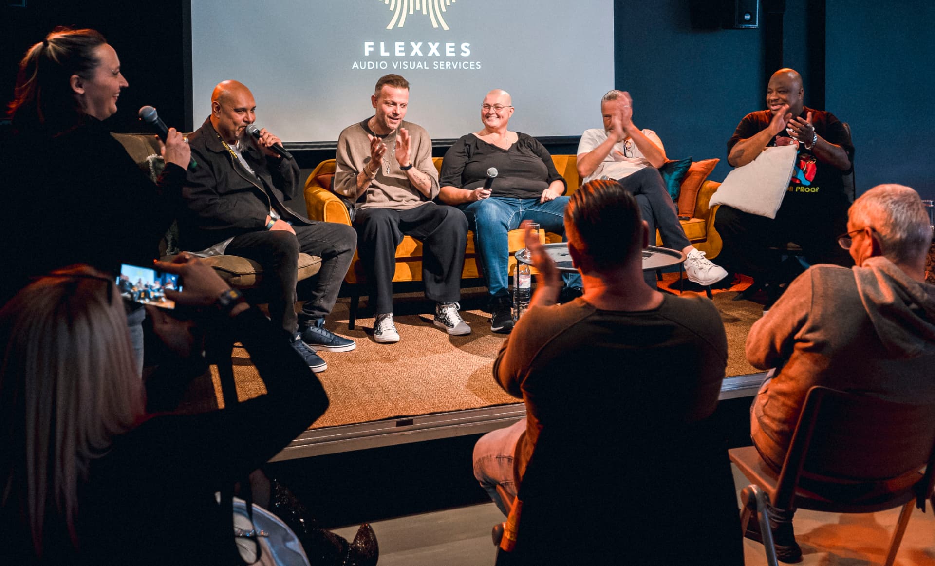 Panelists applauding on stage during the 2023 ADE conference panel